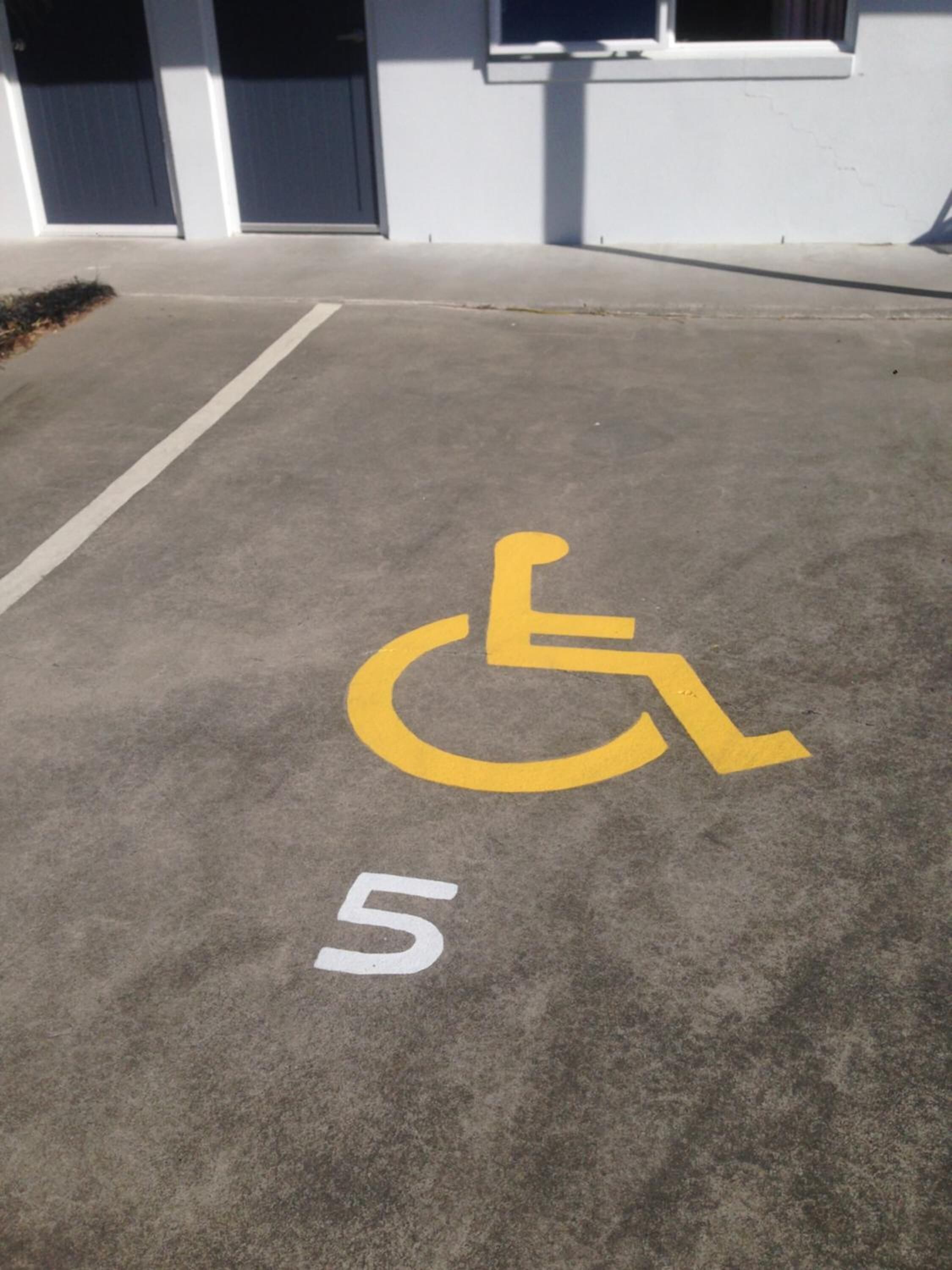 A parking space marked with a wheelchair symbol and the number 5.