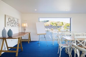 Enjoy a view of the landscaped area from the large window in this room, which features a desk, whiteboard, and comfortable dining area.