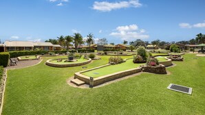 A well-maintained golf course with a putting green, sand bunkers, and a clear blue sky. - Lakeside Country Club - Numurkah (Numurkah)