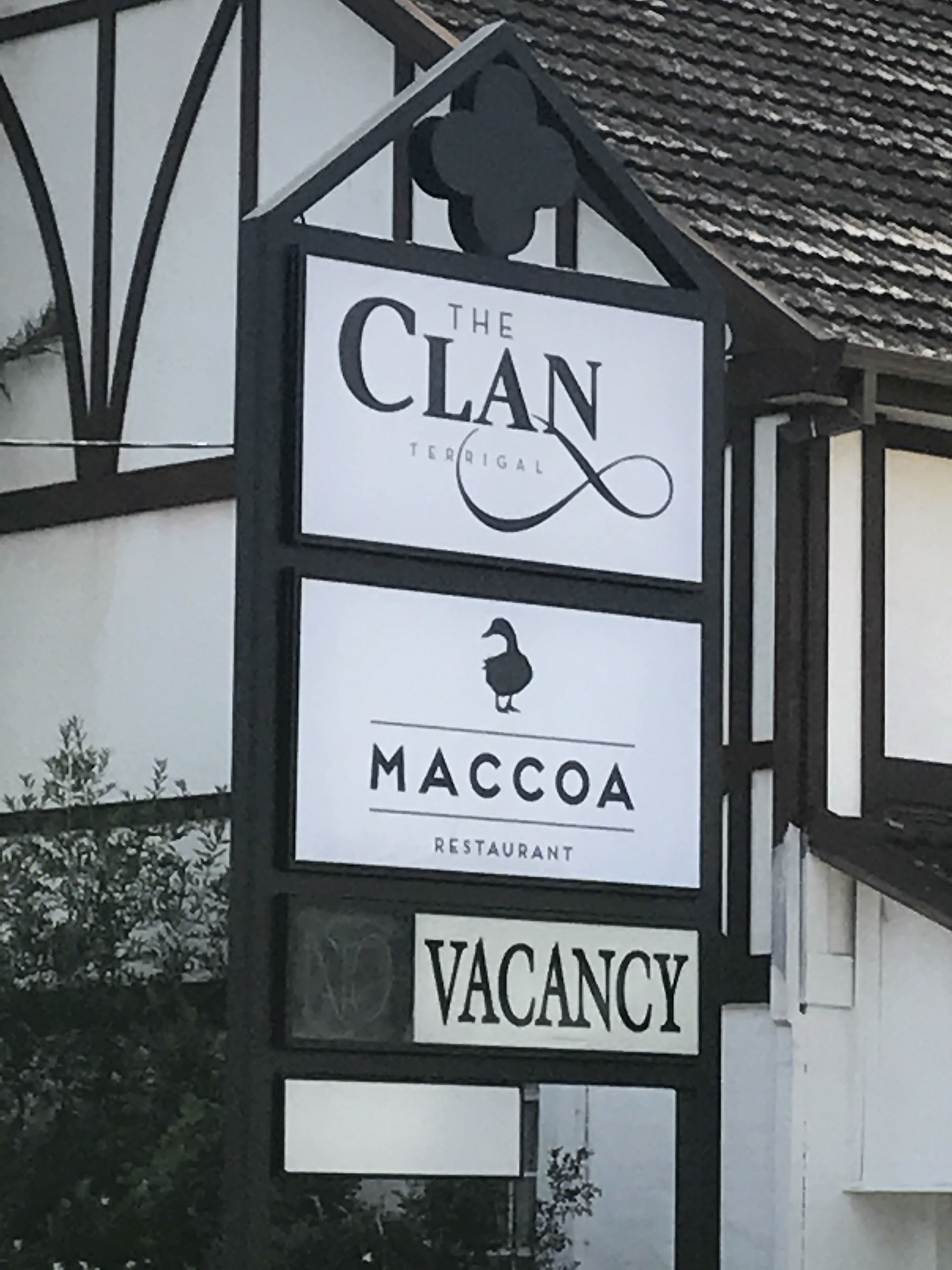 A sign for 'The Clan' restaurant with a 'VACANCY' notice.