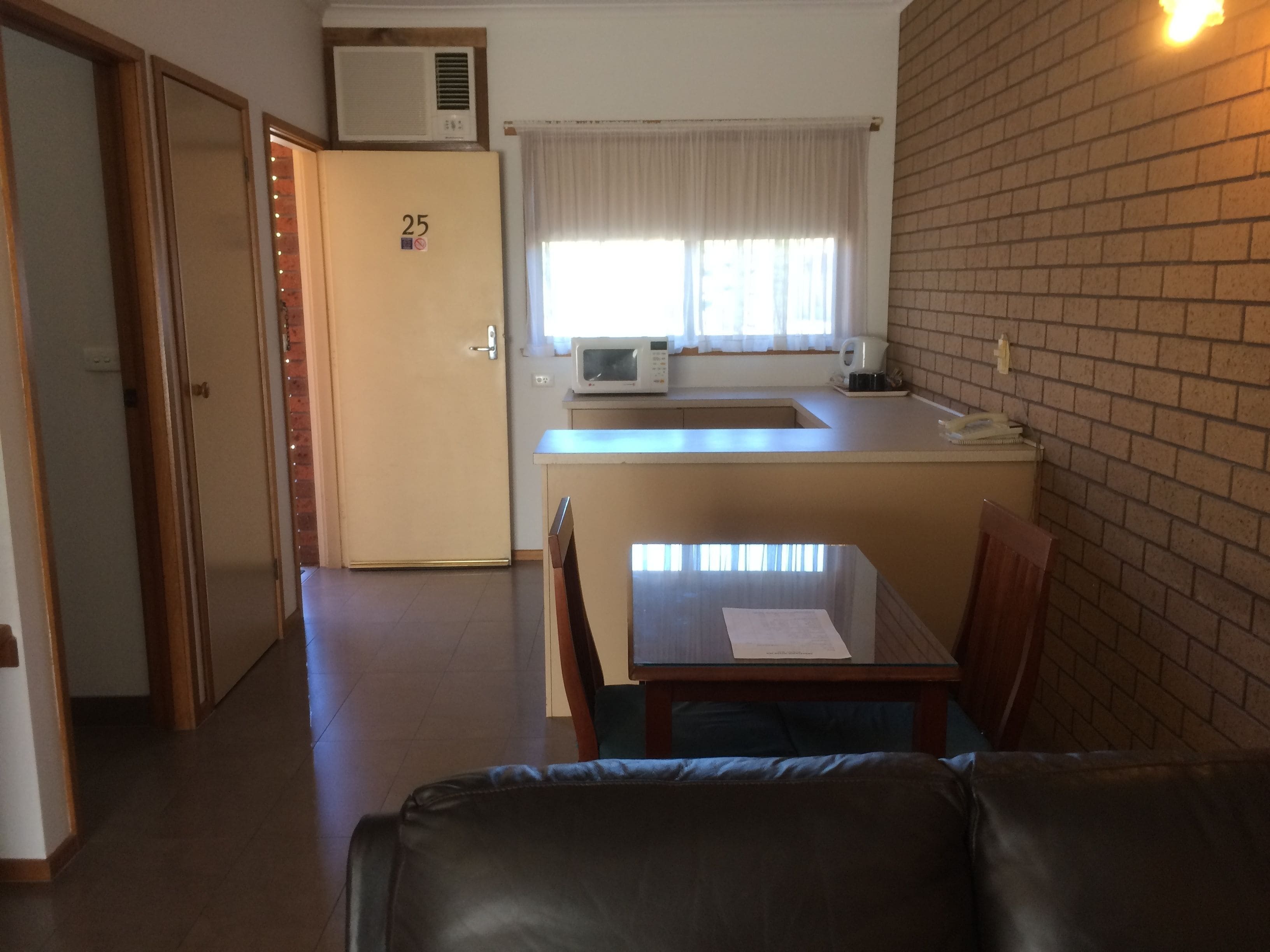 A compact living space with a kitchenette, a dining area, and a seating area.