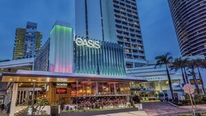 A hotel with a prominent 'OASIS' sign, a 'Sofitel' label, and a 'The Lounge' restaurant. - Tropicana Motel (Mermaid Beach)
