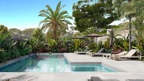 A pool area with lounge chairs, a table with drinks, and tropical plants. - The Hide Byron Bay (Byron Bay)