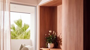 A modern room with a large window, a wooden desk, a chair, and a bed. - The Hide Byron Bay (Byron Bay)