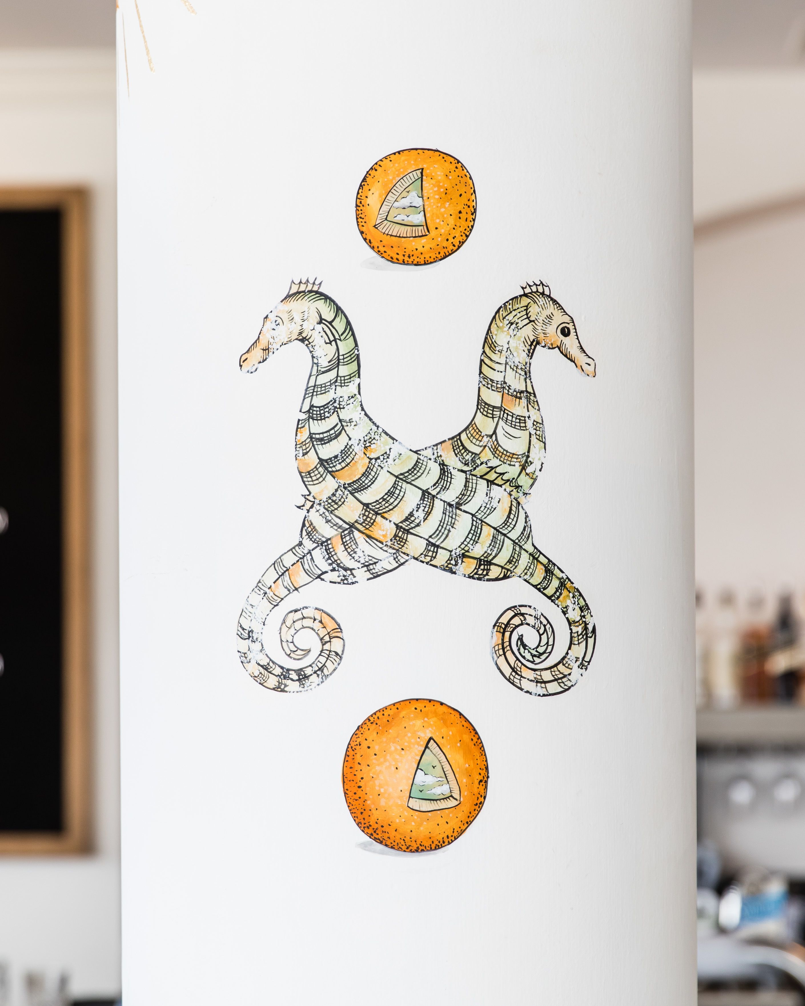 A wall with a seahorse illustration and two orange circles.