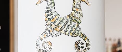 A wall with a seahorse illustration and two orange circles.