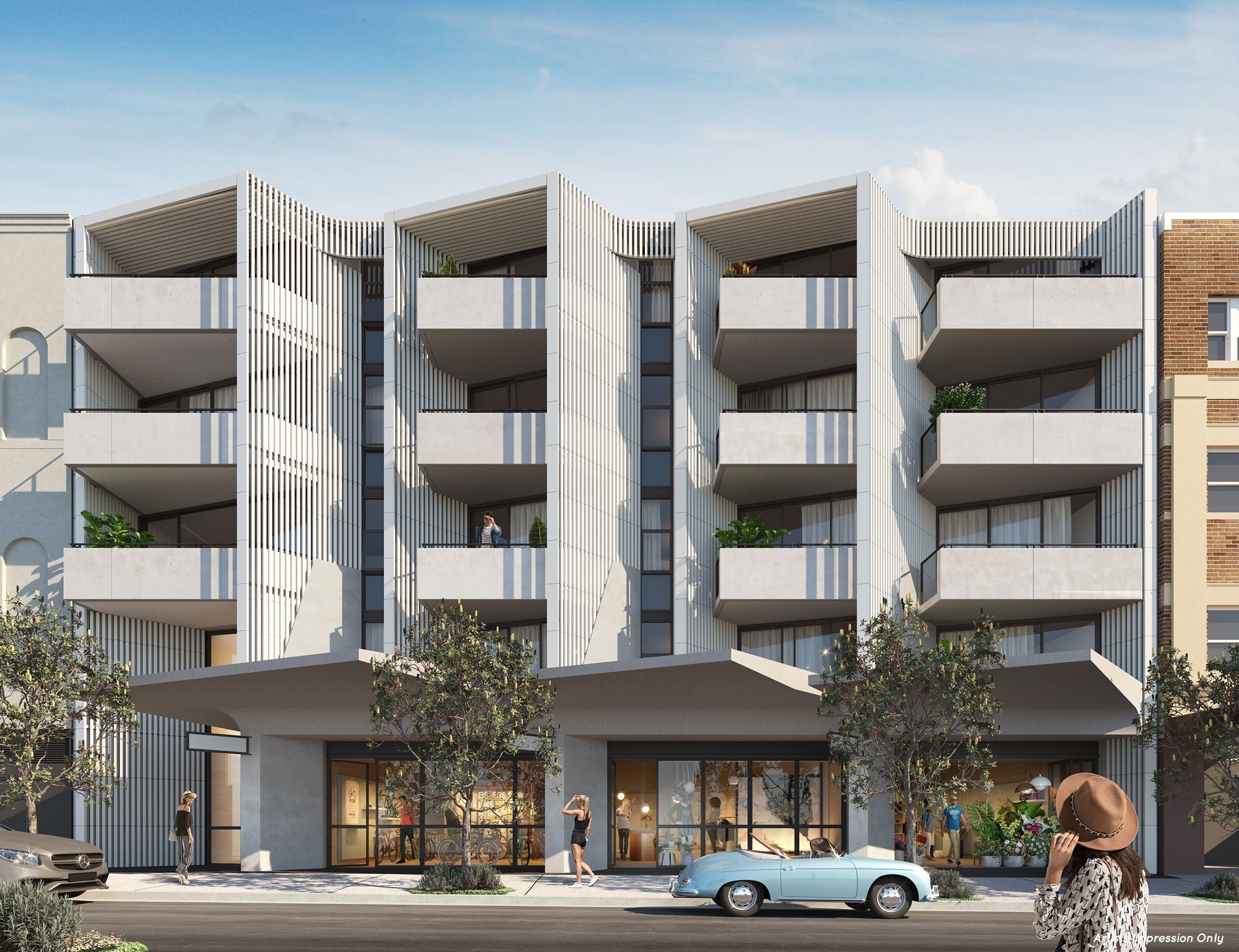 A modern building with multiple balconies, a storefront with a bicycle display, and a vintage car parked in front.