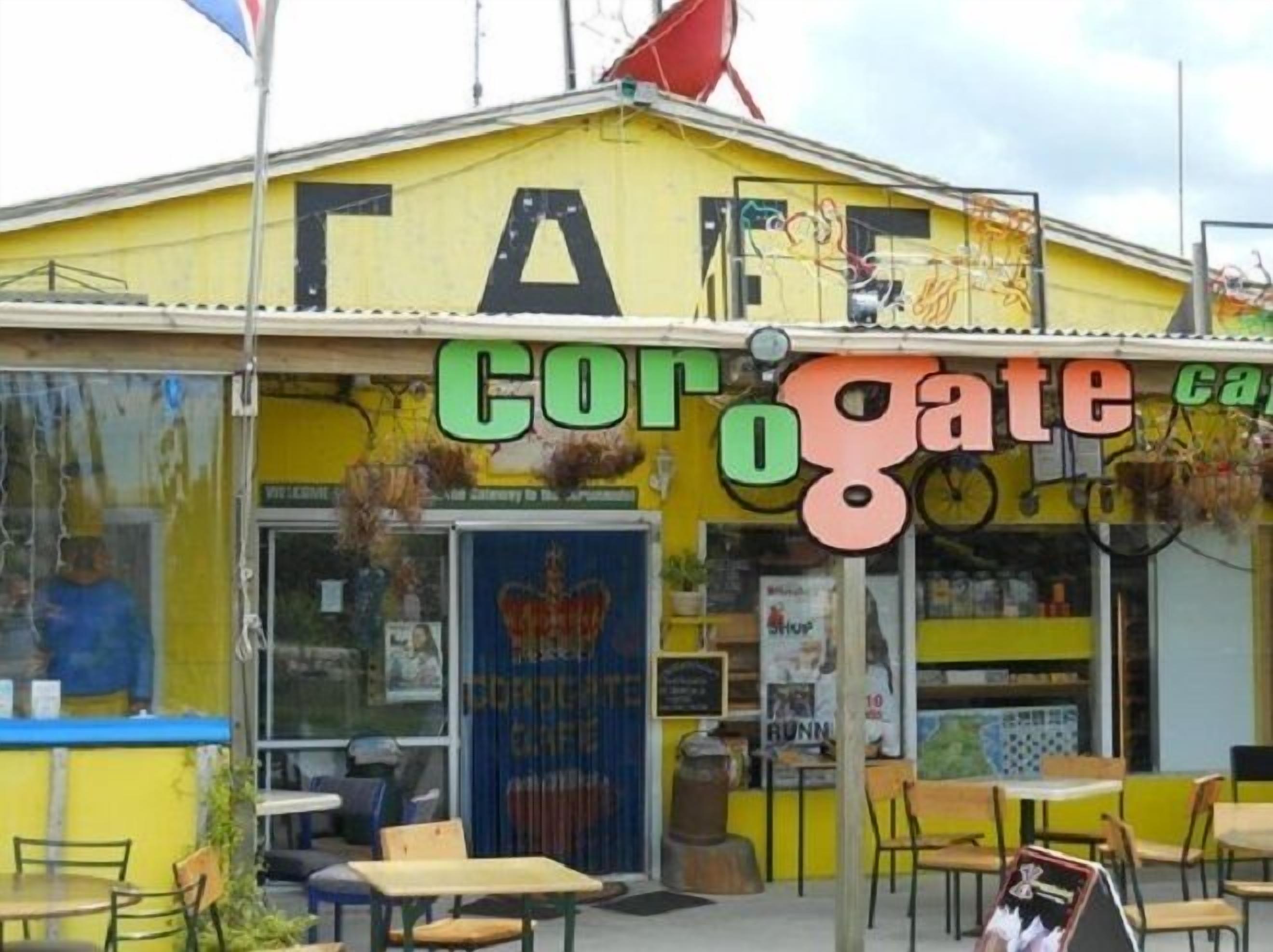 A yellow building with a sign that reads "Corogate Cafe".