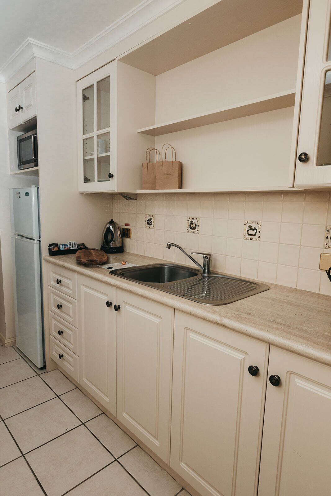 Fridge, microwave, electric kettle, cookware/dishes/utensils