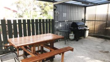 Enjoy al fresco dining on the patio, where a barbecue grill and picnic table await.