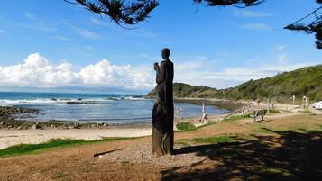 Guests can enjoy ocean views from a scenic walkway leading to a serene beach.