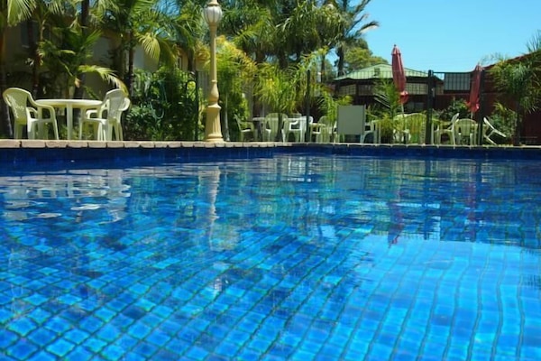 Outdoor pool, open 8:00 AM to 10:00 PM, sun loungers