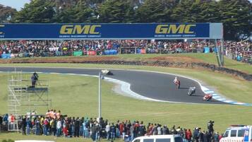 A race track with a crowd of spectators and a GMC advertisement.