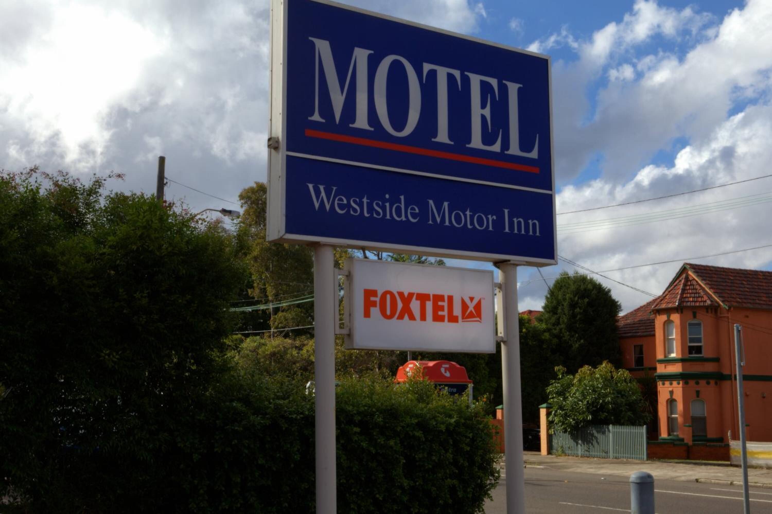 A motel sign with the name 'Westside Motor Inn' and a 'FOXTEL' logo.