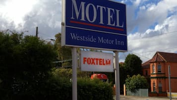 A motel sign with the name 'Westside Motor Inn' and a 'FOXTEL' logo.