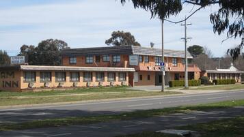 Welcome to Lyneham Motor Inn, a two-story motel with a brick facade and air-conditioned rooms.