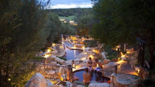 A natural hot spring area with wooden walkways and stone seating. - Bayplay Beach Accommodation - 2 locations (Portsea)
