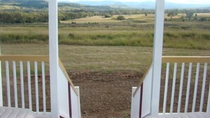 A porch with a view of a rural landscape. - Rangemore Estate (Moola)