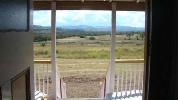 A room with a view of a grassy field and mountains. - Rangemore Estate (Moola)