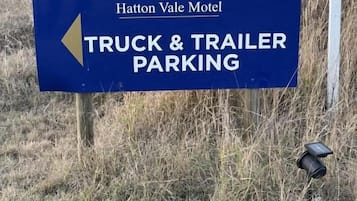 Señal del motel Hatton Vale que indica estacionamiento para camiones y remolques.