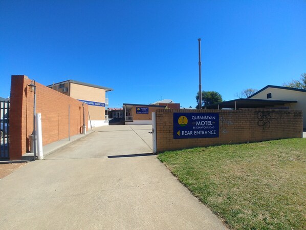 The entrance to Queanbeyan Motel with a clear pathway leading to the main building.
