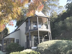 A two-story building with a balcony on the upper floor.