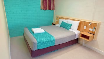 Colchones con acolchado adicional y tabla de planchar con plancha