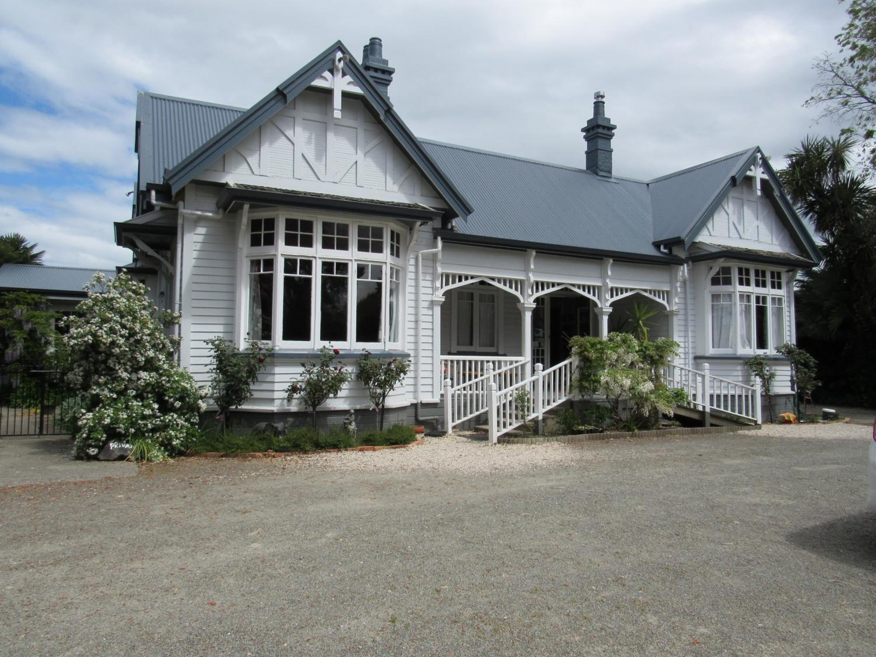 A large, two-story house with a prominent front porch and multiple windows.