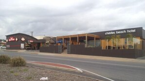 A modern building with a sign for 'Christies Beach Hotel'. - Christies Beach Hotel (Christies Beach)