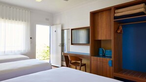 A hotel room with two beds, a desk, a wardrobe, and a large window with curtains. - The Sails Motel Brunswick Heads (Brunswick Heads)