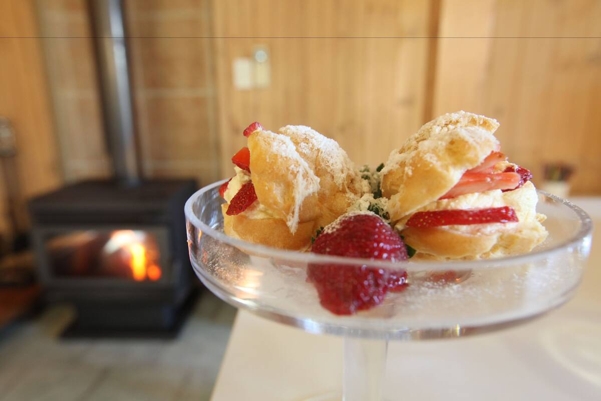 A dessert plate with pastries and strawberries.