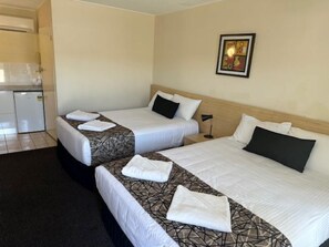 A hotel room with two beds, a small kitchenette, and a framed picture on the wall. - City Centre Motel (Kempsey)