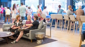 A spacious lounge area with multiple seating options including sofas and chairs, a coffee table, and a small side table. - Rsl Club Motel (Wagga Wagga)