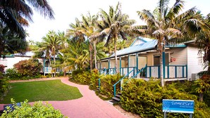 A pathway leading to a building with a sign reading "Somerset Apartments."