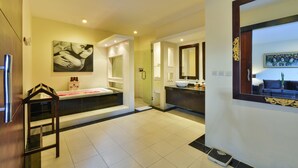A modern bathroom with a large bathtub, a vanity with a sink, and a mirror. - The Yubi Boutique Villas Seminyak (Seminyak)