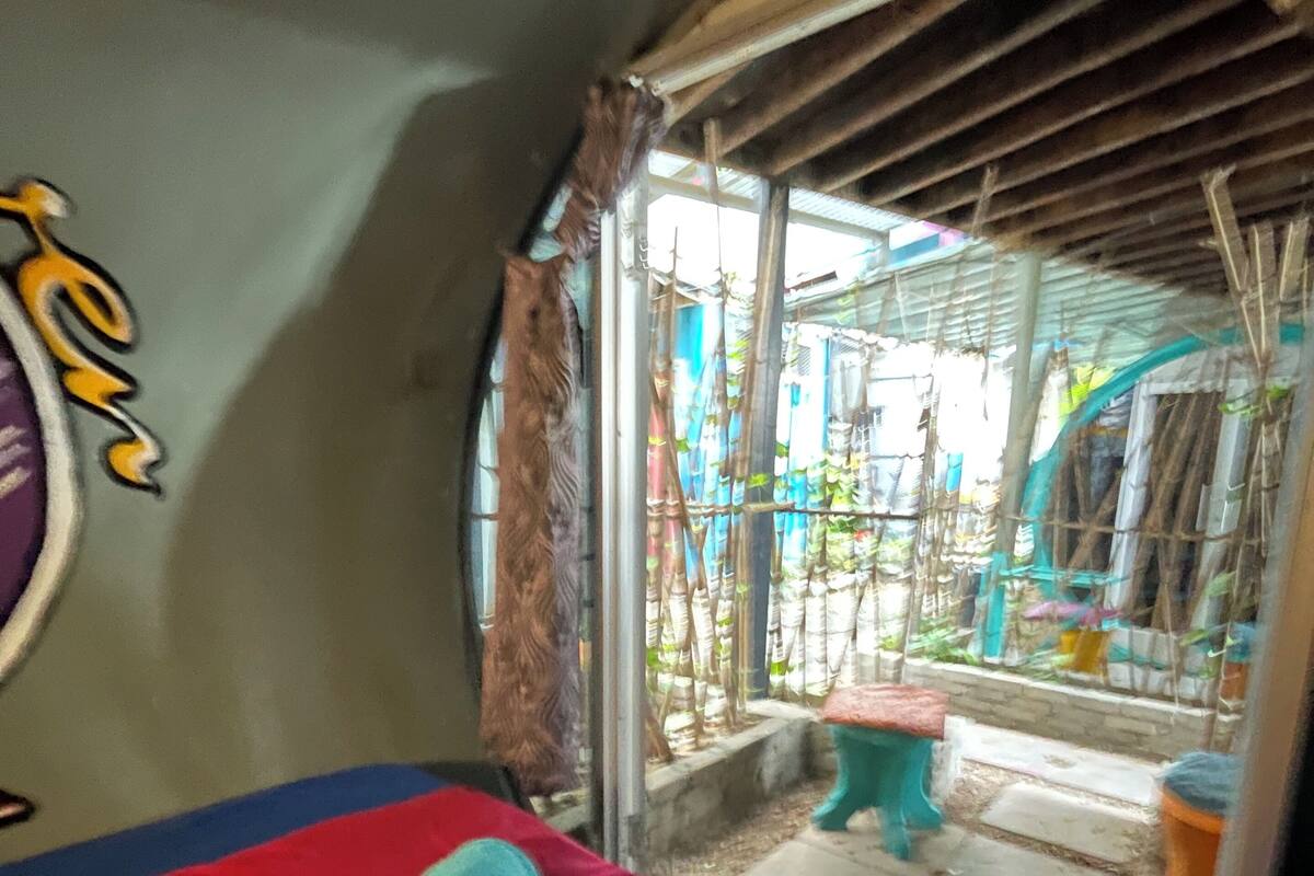 A room with a bed, a small table, and a window.