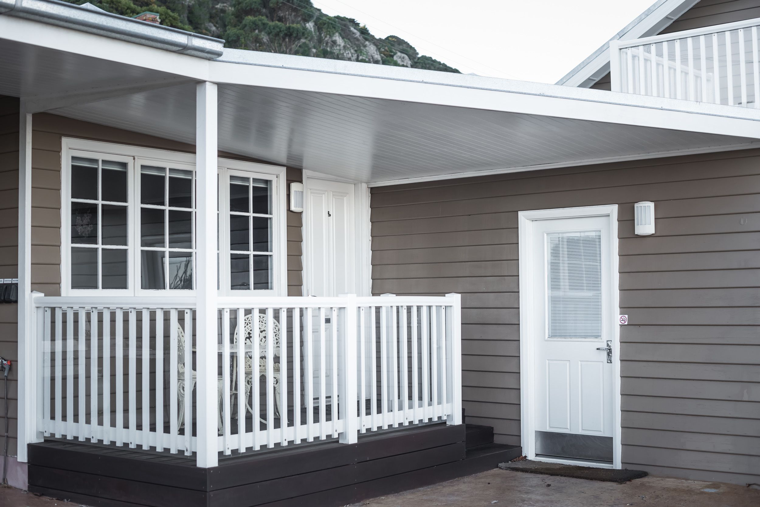 A house with a porch, a door, and a window.