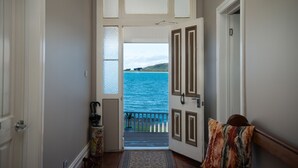 A hallway with a view of the ocean through a door. - The Ark Stanley (Stanley)