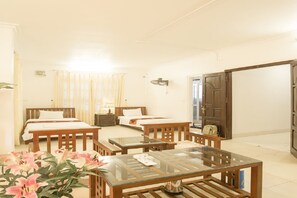 A hotel room with two beds, a glass-top table, wooden furniture, and a view of the outside. - Trang An Plaza Hotel (Hanoi)