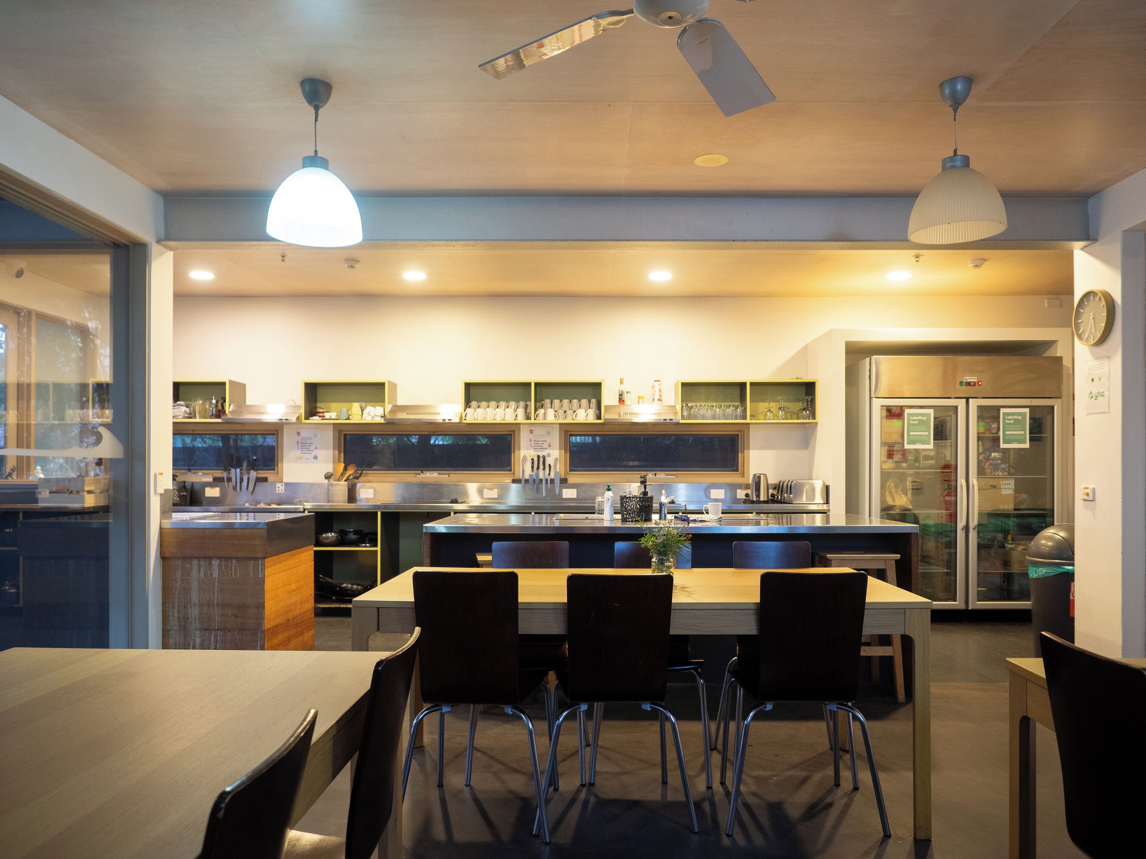 A modern kitchen with a central island, built-in appliances, and pendant lighting.