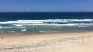 Una playa con olas y cielo despejado.