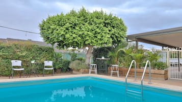 Outdoor pool, open 10:00 AM to 9:00 PM, pool loungers