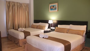 A hotel room with two beds, a nightstand, a lamp, and a painting on the wall. - Alami Garden Hotel (Shah Alam)