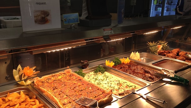 A buffet with various dishes including poached eggs, salads, and meat platters. - Karratha Lodge (Karratha Industrial Estate)