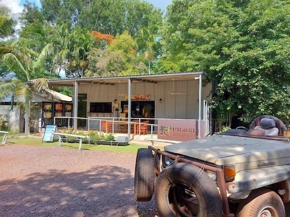 A rustic building with a covered porch and a sign that reads "Lighthouse Tours."