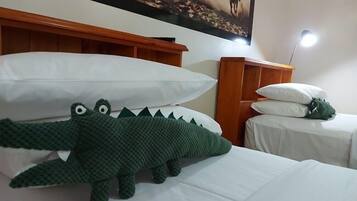 A hotel room with a bed, a nightstand, a lamp, and a painting on the wall.