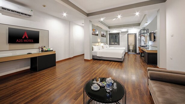 Family Suite Room | Minibar, in-room safe, blackout drapes, iron/ironing board