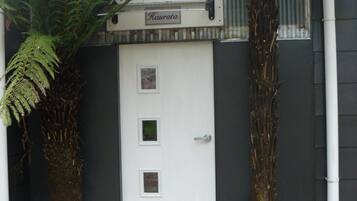 A white door with a small window and a sign above it.