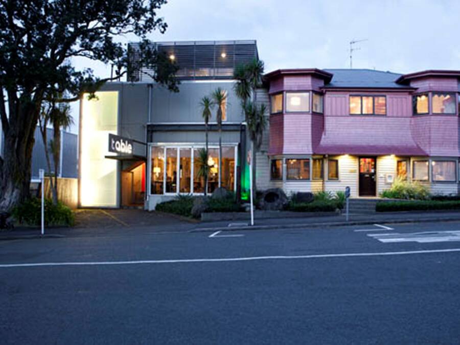 A modern building with a restaurant named "table" on the ground floor.