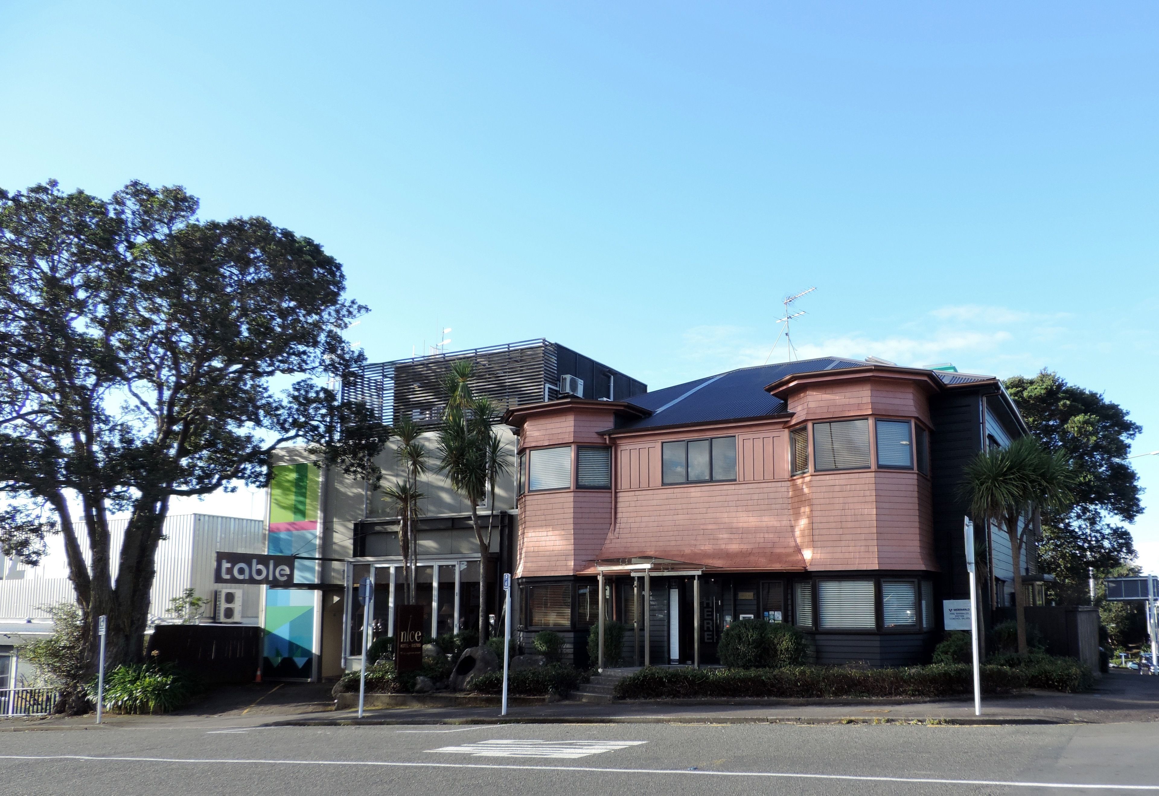 A multi-story building with a modern architectural design, featuring a mix of curved and straight lines.